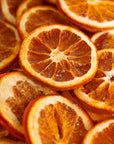 Close-up of dehydrated orange slices used as cocktail garnishes or drink toppers.
