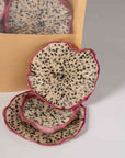 Dehydrated dragon fruit slices with pink edges on white background