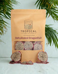 Bag of dehydrated dragonfruit slices with tropical leaves background