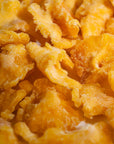 Close-up of golden dehydrated pineapple slices, used as fruit garnish.