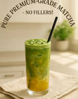 Iced matcha latte with vibrant green and yellow layers in a glass with a straw
